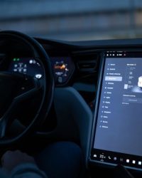 Tesla car interior showcasing advanced touchscreen display and steering controls.